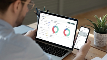 man using Medius Expense on computer and mobile device